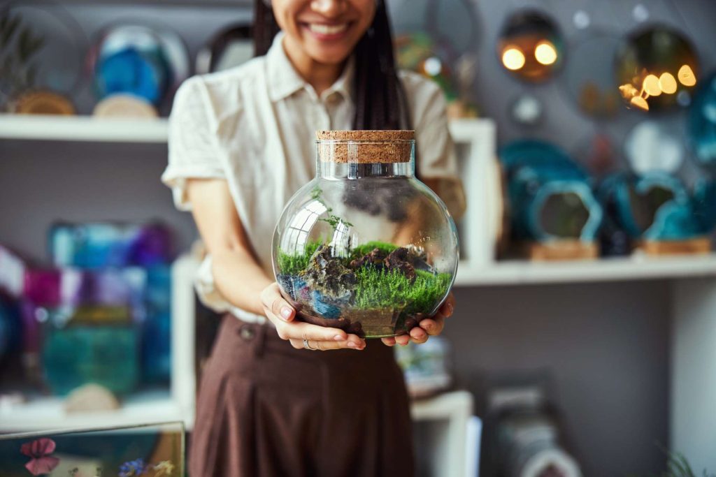 Floral designer showing off her terrarium.