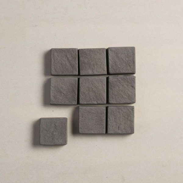 Top view nine charcoal coloured cobblestone pavers | Featured image for Cobblestone Paver.